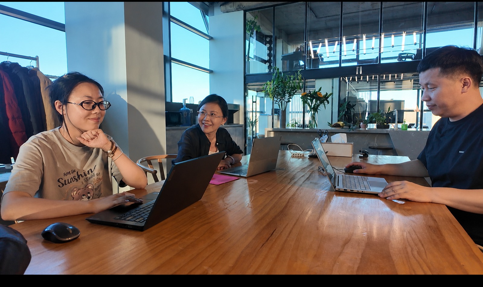 MORO team collaborating around laptops in the studio