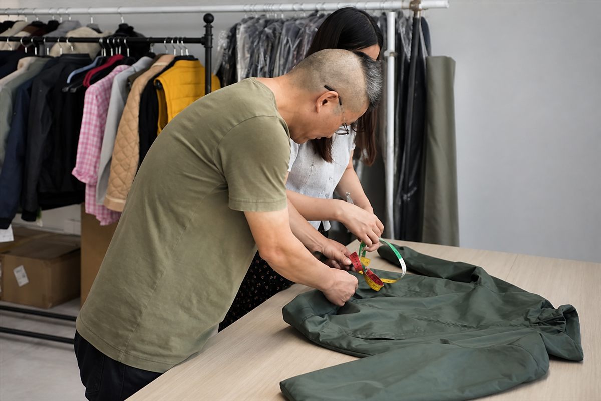 MORO team checking measurements on a finished outerwear sample